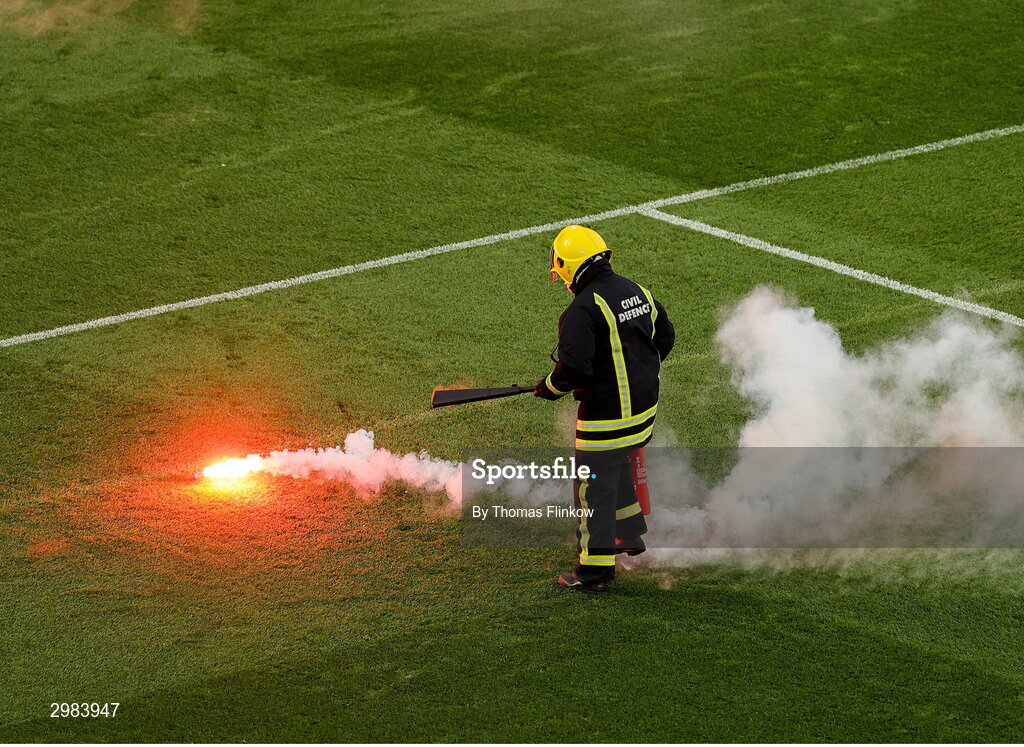 10 November 2024; A member of the Civil Defence takes away a flare during the Sports Direct Men's FAI Cup Final match between Drogheda United and Derry City at the Aviva Stadium in Dublin. Photo by Thomas Flinkow/Sportsfile