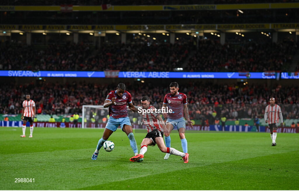 10 November 2024; Michael Duffy of Derry City in action against Elicha Ahui, left, and Luke Heeney of Drogheda United during the Sports Direct Men's FAI Cup Final match between Drogheda United and Derry City at the Aviva Stadium in Dublin. Photo by Stephen McCarthy/Sportsfile
