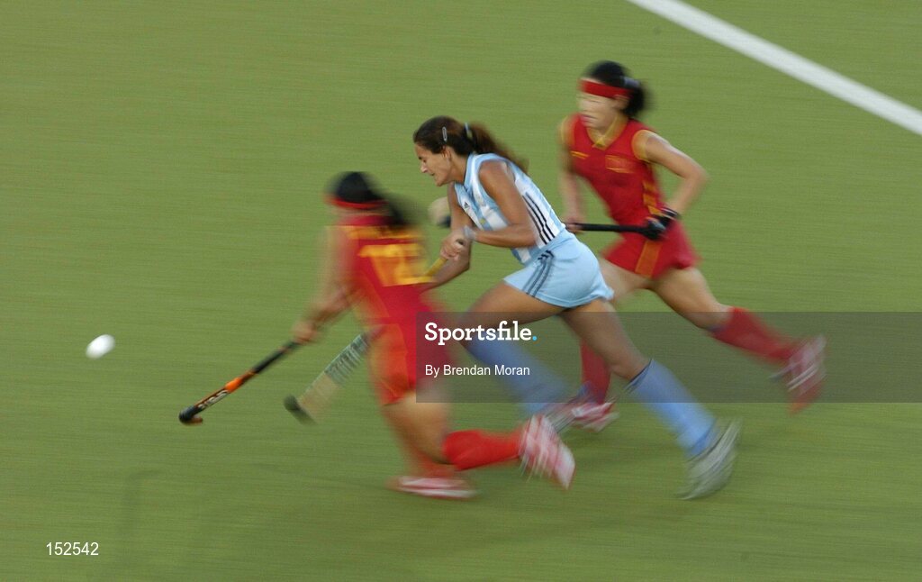 26 August 2004; Luciana Aymar, Argentina, goes past Zhou Wangfeng, left, and Ma Yibo, China, on her way to score her sides winning goal. Bronze Medal Match, Argentina v China, Olympic Hockey Centre, Helliniko Sports Complex. Games of the XXVIII Olympiad, Athens Summer Olympics Games 2004, Athens, Greece. Picture credit; Brendan Moran / SPORTSFILE