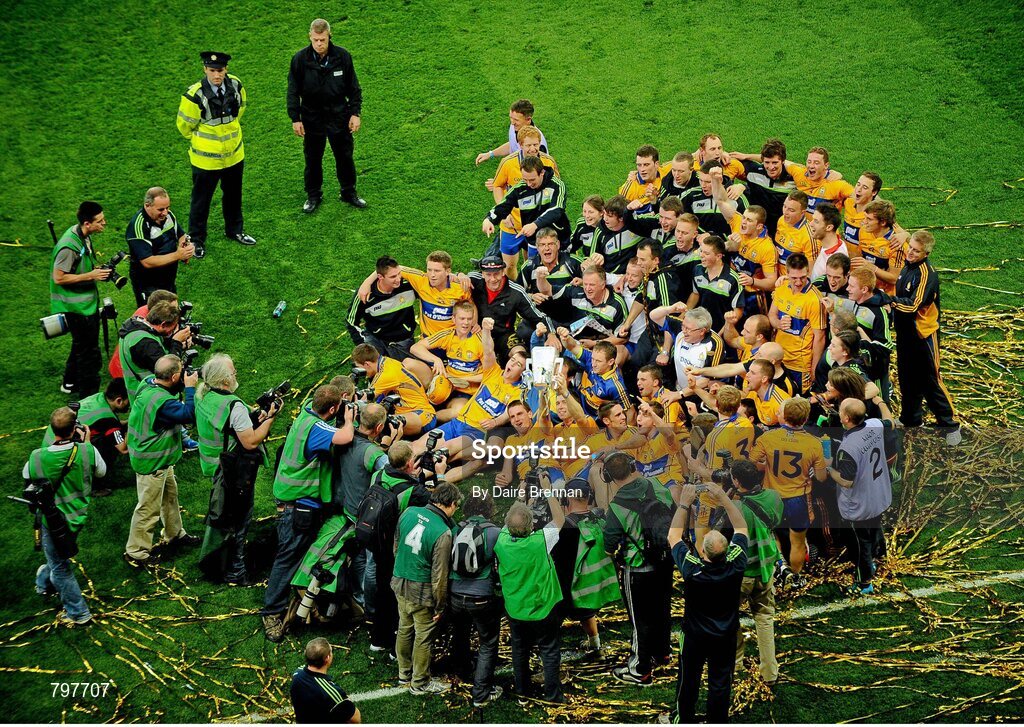 28 September 2013; John Conlon, Clare, holds up the Liam MacCarthy cup surrounded by team-mates, and in front of photographers. GAA Hurling All-Ireland Senior Championship Final Replay, Cork v Clare, Croke Park, Dublin. Picture credit: Daire Brennan / SPORTSFILE