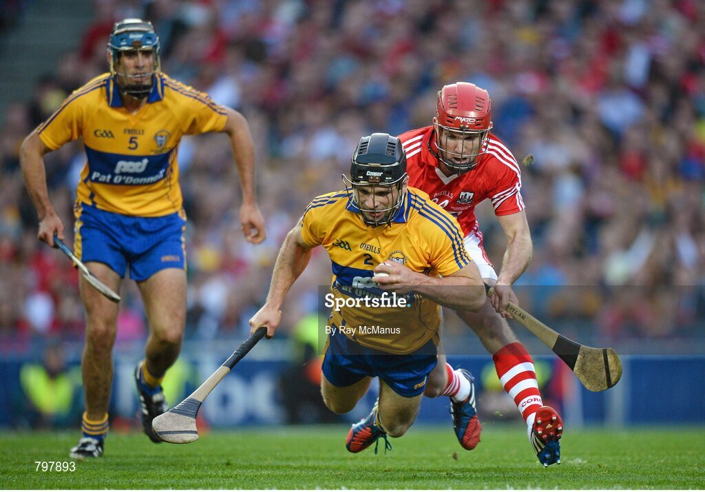 28 September 2013; Clare corner back Domhnall O'Donovan, supported by Brendan Bugler, catches the sliothar under pressure from Cork's Stephen Moylan late in the game. GAA Hurling All-Ireland Senior Championship Final Replay, Cork v Clare, Croke Park, Dublin. Picture credit: Ray McManus / SPORTSFILE