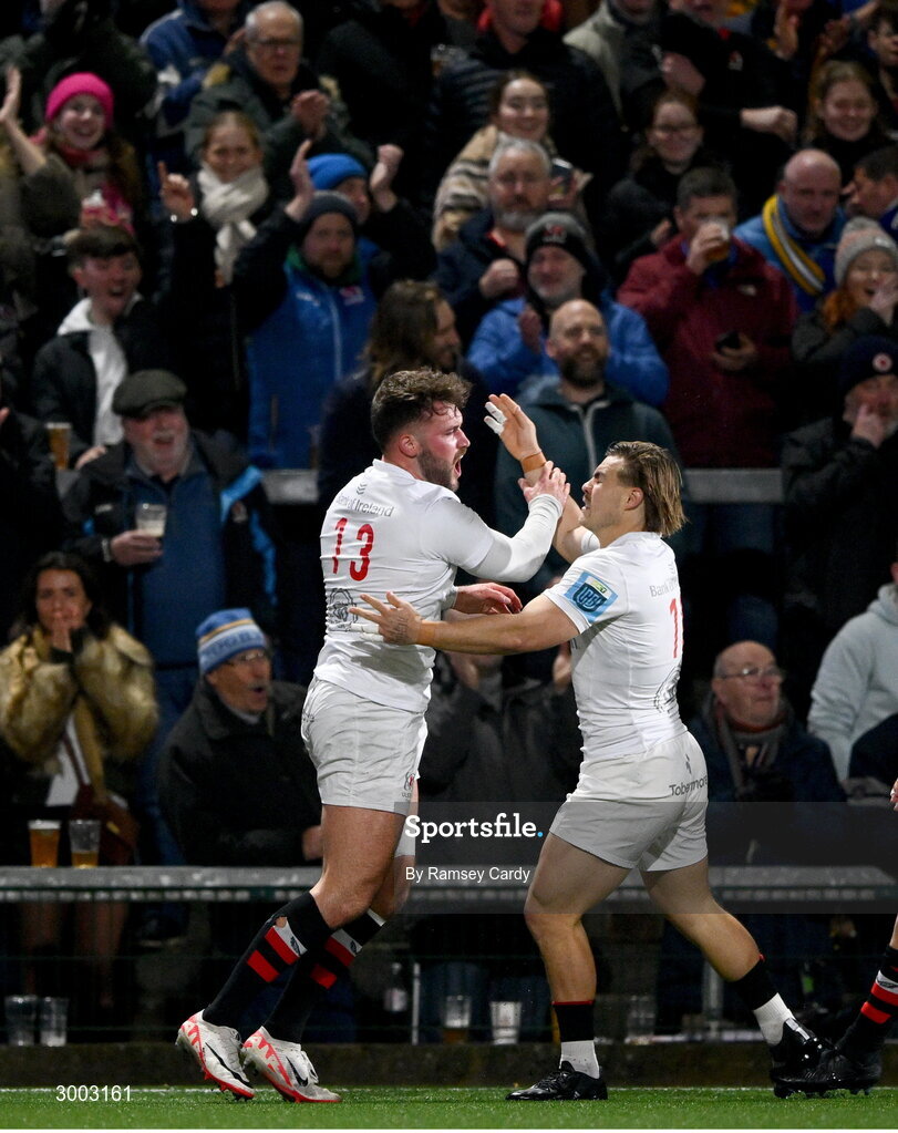 29 November 2024; Ben Carson of Ulster celebrates with teammate Aidan Morgan after scoring their side's first try during the United Rugby Championship match between Ulster and Leinster at Kingspan Stadium in Belfast. Photo by Ramsey Cardy/Sportsfile