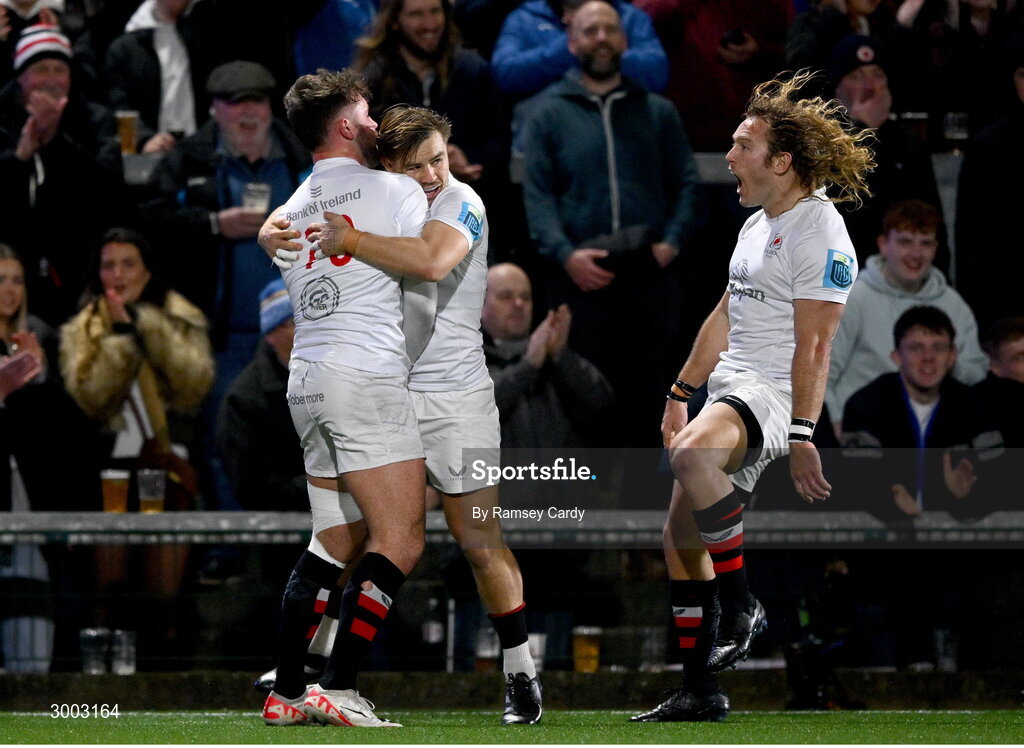 29 November 2024; Ben Carson of Ulster, left, celebrates with teammates Aidan Morgan and Werner Kok after scoring their side's first try during the United Rugby Championship match between Ulster and Leinster at Kingspan Stadium in Belfast. Photo by Ramsey Cardy/Sportsfile