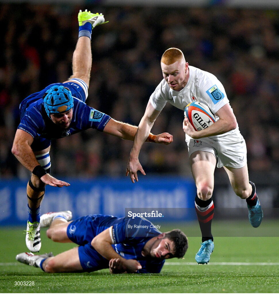 29 November 2024; Nathan Doak of Ulster evades the tackle of Will Connors and Jimmy O'Brien of Leinster during the United Rugby Championship match between Ulster and Leinster at Kingspan Stadium in Belfast. Photo by Ramsey Cardy/Sportsfile