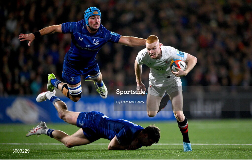 29 November 2024; Nathan Doak of Ulster evades the tackle of Will Connors and Jimmy O'Brien of Leinster during the United Rugby Championship match between Ulster and Leinster at Kingspan Stadium in Belfast. Photo by Ramsey Cardy/Sportsfile