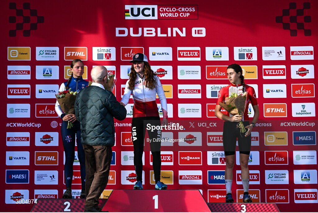 1 December 2024; On the podium after the women's U19 race, race winner Lidia Cusack of USA, centre, second place Lison Desprez of France, left, and third place Rafaelle Carrier of Canada, with Dr Tom Daly, President of Cycling Ireland at the UCI Cyclo-cross World Cup on the Sport Ireland Campus in Dublin. Photo by David Fitzgerald/Sportsfile