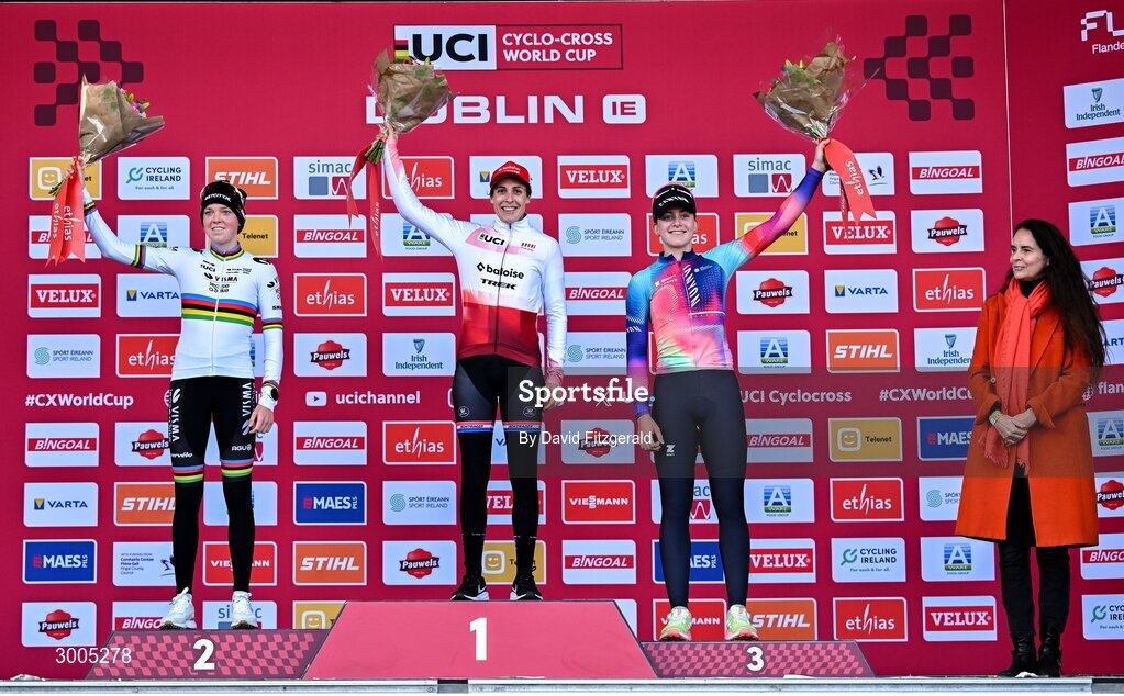 1 December 2024; On the podium after the Women's Elite race, race winner Lucinda Brown of Netherlands, centre, accepting award, second place Fem van Empel of Netherlands, left, and third place Zoe Backstedt of Great Britain with Karen Van Vlierberge, ambassador of Belgium to Ireland at the UCI Cyclo-cross World Cup on the Sport Ireland Campus in Dublin. Photo by David Fitzgerald/Sportsfile