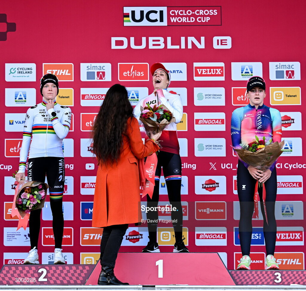1 December 2024; On the podium after the Women's Elite race are, race winner Lucinda Brown of Netherlands, centre, accepting award from Karen Van Vlierberge, ambassador of Belgium to Ireland, second place Fem van Empel of Netherlands, left, and third place Zoe Backstedt of Great Britain, at the UCI Cyclo-cross World Cup on the Sport Ireland Campus in Dublin. Photo by David Fitzgerald/Sportsfile