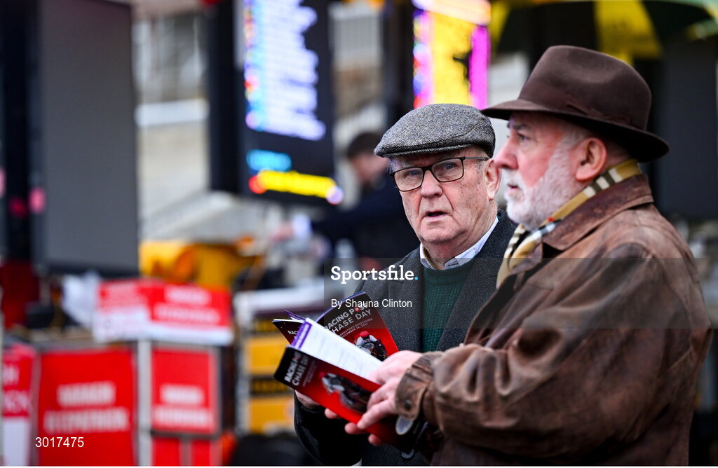 26 December 2024; Two Racegoers inspect the odds board on day one of the Leopardstown Christmas Festival at Leopardstown Racecourse in Dublin. Photo by Shauna Clinton/Sportsfile