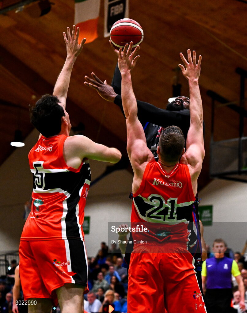 18 January 2025; Elijah Tillman of UCC Demons in action against Killester players Andrew McGeever, left, and Baptiste Chazelas during the Basketball Ireland Men's Pat Duffy National Cup final match between Killester and UCC Demons at the National Basketball Arena in Tallaght, Dublin. Photo by Shauna Clinton/Sportsfile