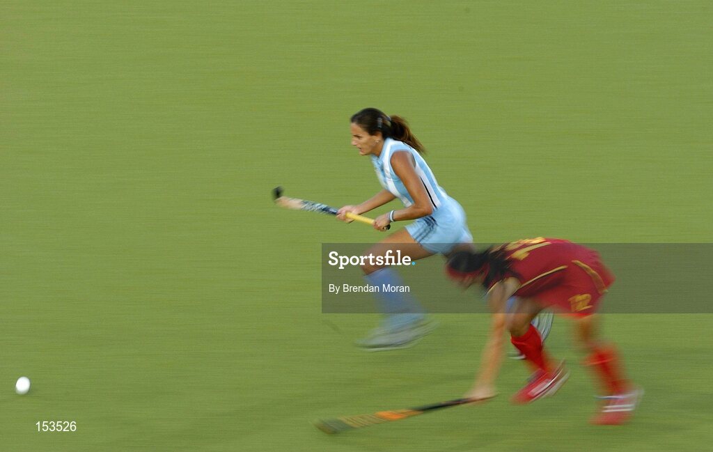 26 August 2004; Luciana Aymar, Argentina, goes past Ma Yibo, China, on her way to score her sides winning goal. Bronze Medal Match, Argentina v China, Olympic Hockey Centre, Helliniko Sports Complex. Games of the XXVIII Olympiad, Athens Summer Olympics Games 2004, Athens, Greece. Picture credit; Brendan Moran / SPORTSFILE