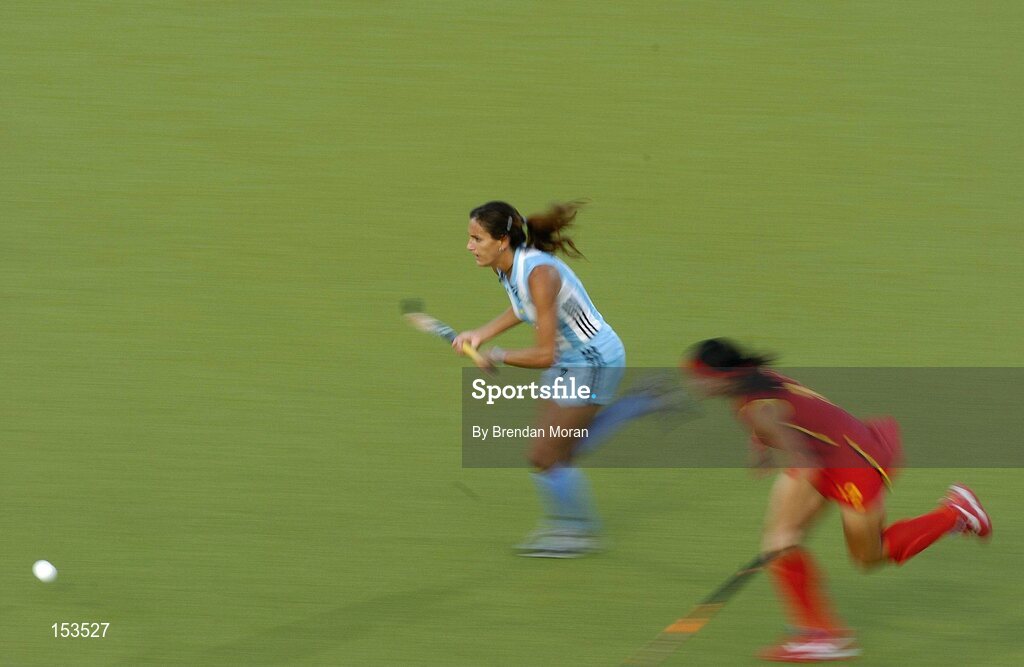 26 August 2004; Luciana Aymar, Argentina, goes past Zhou  Ma Yibo, China, on her way to score her sides winning goal. Bronze Medal Match, Argentina v China, Olympic Hockey Centre, Helliniko Sports Complex. Games of the XXVIII Olympiad, Athens Summer Olympics Games 2004, Athens, Greece. Picture credit; Brendan Moran / SPORTSFILE
