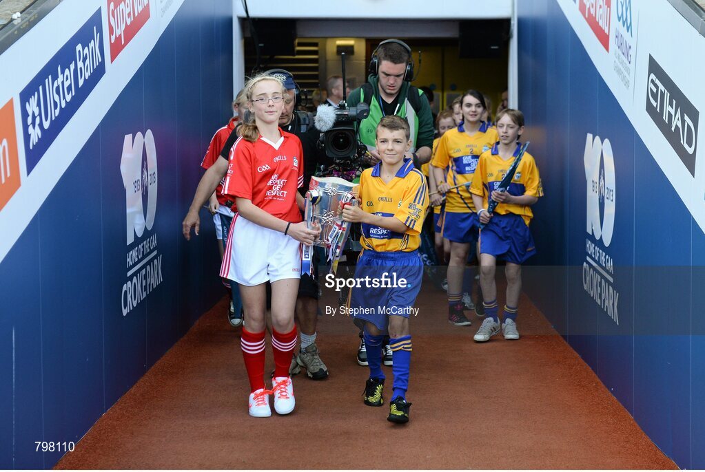 28 September 2013; Barry Morrissey, Clarecastle NS, Co. Clare, and Aine O'Regan, Scoil Bhailenora, Ballinora, Co. Cork. bring out Liam MacCarthy cup. GAA Hurling All-Ireland Senior Championship Final Replay, Cork v Clare, Croke Park, Dublin. Picture credit: Stephen McCarthy / SPORTSFILE