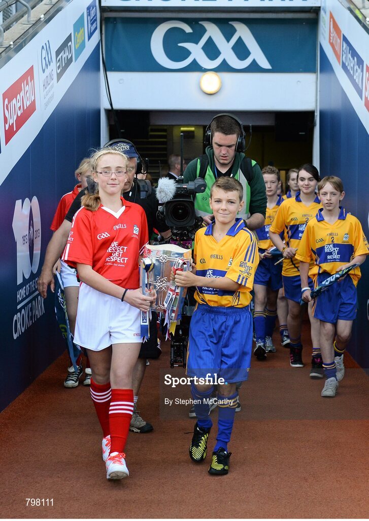 28 September 2013; Barry Morrissey, Clarecastle NS, Co. Clare, and Aine O'Regan, Scoil Bhailenora, Ballinora, Co. Cork. bring out Liam MacCarthy cup. GAA Hurling All-Ireland Senior Championship Final Replay, Cork v Clare, Croke Park, Dublin. Picture credit: Stephen McCarthy / SPORTSFILE