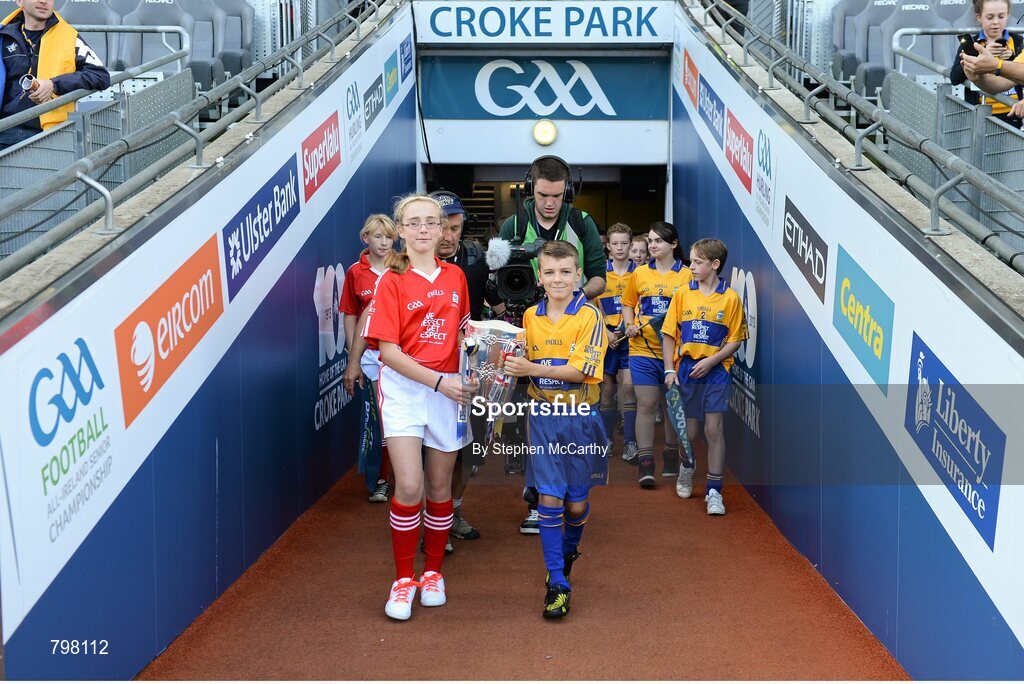 28 September 2013; Barry Morrissey, Clarecastle NS, Co. Clare, and Aine O'Regan, Scoil Bhailenora, Ballinora, Co. Cork. bring out Liam MacCarthy cup. GAA Hurling All-Ireland Senior Championship Final Replay, Cork v Clare, Croke Park, Dublin. Picture credit: Stephen McCarthy / SPORTSFILE