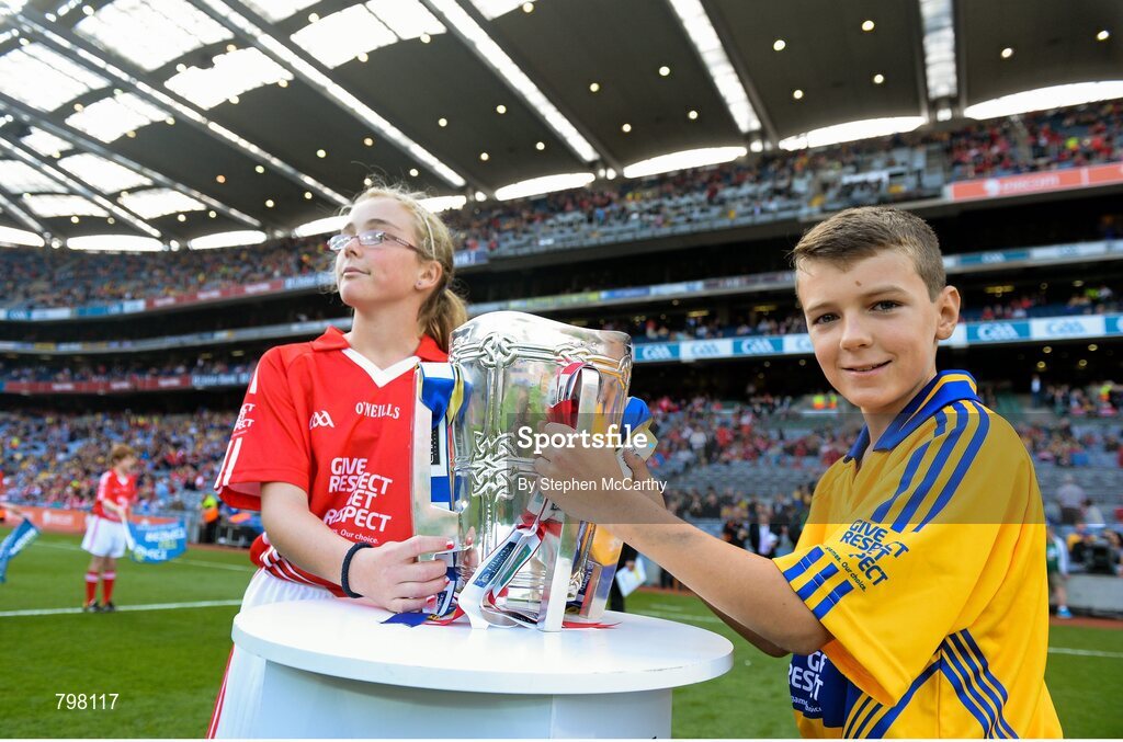 28 September 2013; Barry Morrissey, Clarecastle NS, Co. Clare, and Aine O'Regan, Scoil Bhailenora, Ballinora, Co. Cork. bring out Liam MacCarthy cup. GAA Hurling All-Ireland Senior Championship Final Replay, Cork v Clare, Croke Park, Dublin. Picture credit: Stephen McCarthy / SPORTSFILE