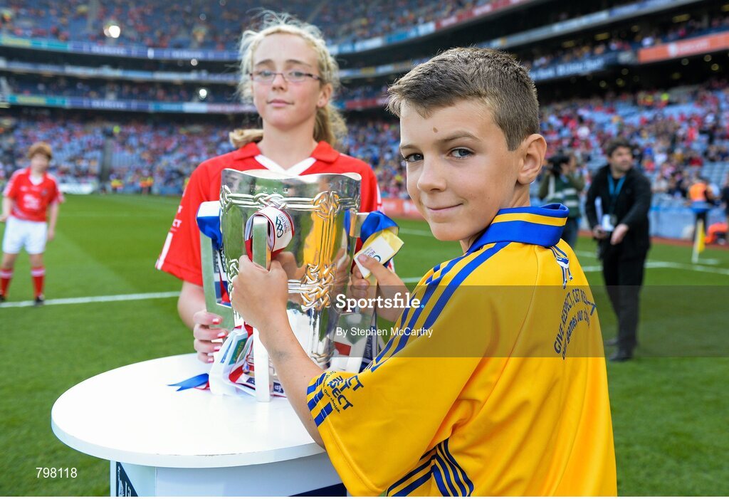 28 September 2013; Barry Morrissey, Clarecastle NS, Co. Clare, and Aine O'Regan, Scoil Bhailenora, Ballinora, Co. Cork. bring out Liam MacCarthy cup. GAA Hurling All-Ireland Senior Championship Final Replay, Cork v Clare, Croke Park, Dublin. Picture credit: Stephen McCarthy / SPORTSFILE