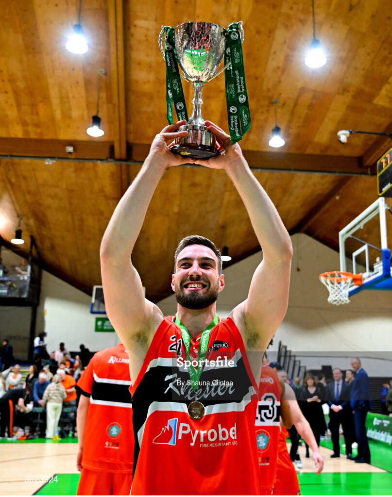 18 January 2025; Baptiste Chazelas of Killester celebrates with the Pat Duffy Cup after his side's victory in the Basketball Ireland Men's Pat Duffy National Cup final match between Killester and UCC Demons at the National Basketball Arena in Tallaght, Dublin. Photo by Shauna Clinton/Sportsfile