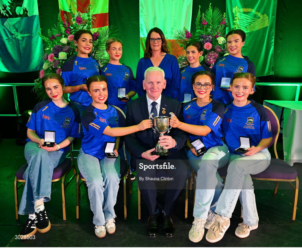 25 January 2025; Winners of the Rince Foirne competition, The CLG Caisleán Nua team, including Cara Cullinane, Caoimhe Leahy, Jessica Davis, Mia Keague, Sarah Brophy, Jennifer Langton, Kate Walsh and Anna English, representing Tipperary and Munster, with Uachtarán Chomhairle Uladh C.L.G Micheál Mag Eochagáin and Cathaoirleach Coiste Náisiúnta Scór Paula Magee during the Scór na nÓg 2024-25 All-Ireland Finals at the Hillgrove Hotel, Monaghan. Photo by Shauna Clinton/Sportsfile