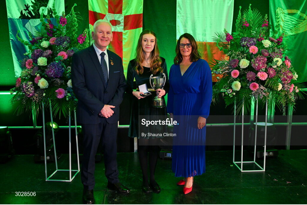 25 January 2025; Winner of the Amhránaíocht Aonair competition, Niamh Noade of An Mullach Bán, representing Armagh and Ulster, with Uachtarán Chomhairle Uladh C.L.G Micheál Mag Eochagáin and Cathaoirleach Coiste Náisiúnta Scór Paula Magee during the Scór na nÓg 2024-25 All-Ireland Finals at the Hillgrove Hotel, Monaghan. Photo by Shauna Clinton/Sportsfile