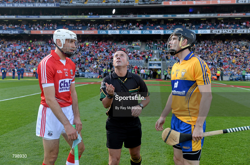 28 September 2013; Cork captain Patrick Cronin and Clare captain Patrick Donnellan look on as referee James McGrath tosses a commemorative Michael Collins coin before the GAA Hurling All-Ireland Senior Championship Final Replay match between Cork and Clare at Croke Park in Dublin. Photo by Ray McManus/Sportsfile
