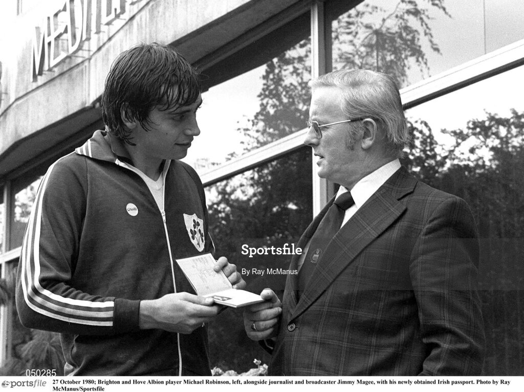 27 October 1980; Brighton and Hove Albion player Michael Robinson, left, alongside journalist and broadcaster Jimmy Magee, with his newly obtained Irish passport. Photo by Ray McManus/Sportsfile