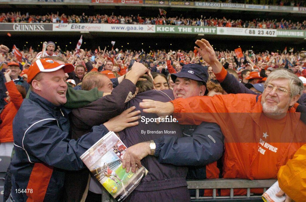 12 September 2004; Cork manager Donal O'Grady is congratulated by Cork fans at the final whistle after victory over Kilkenny. Guinness All-Ireland Senior Hurling Championship Final, Cork v Kilkenny, Croke Park, Dublin. Picture credit; Brendan Moran / SPORTSFILE *** Local Caption *** Any photograph taken by SPORTSFILE during, or in connection with, the 2004 Guinness All-Ireland Hurling Final which displays GAA logos or contains an image or part of an image of any GAA intellectual property, or, which contains images of a GAA player/players in their playing uniforms, may only be used for editorial and non-advertising purposes.  Use of photographs for advertising, as posters or for purchase separately is strictly prohibited unless prior written approval has been obtained from the Gaelic Athletic Association.