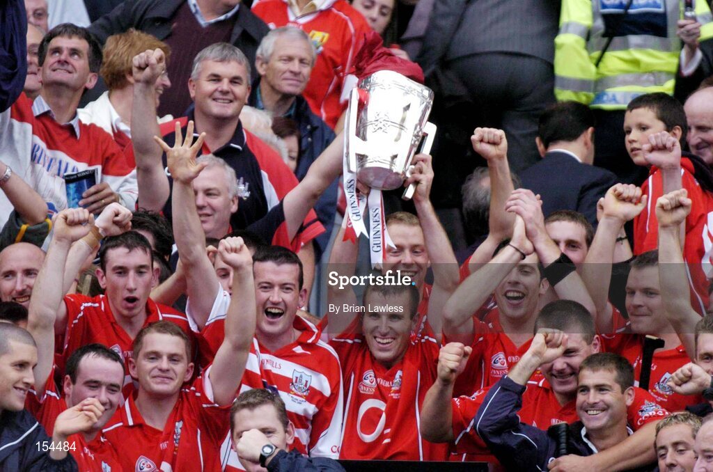 12 September 2004; Members of the Cork squad celebrate with the Liam MacCarthy cup after the game. Guinness All-Ireland Senior Hurling Championship Final, Cork v Kilkenny, Croke Park, Dublin. Picture credit; Brian Lawless / SPORTSFILE *** Local Caption *** Any photograph taken by SPORTSFILE during, or in connection with, the 2004 Guinness All-Ireland Hurling Final which displays GAA logos or contains an image or part of an image of any GAA intellectual property, or, which contains images of a GAA player/players in their playing uniforms, may only be used for editorial and non-advertising purposes.  Use of photographs for advertising, as posters or for purchase separately is strictly prohibited unless prior written approval has been obtained from the Gaelic Athletic Association.