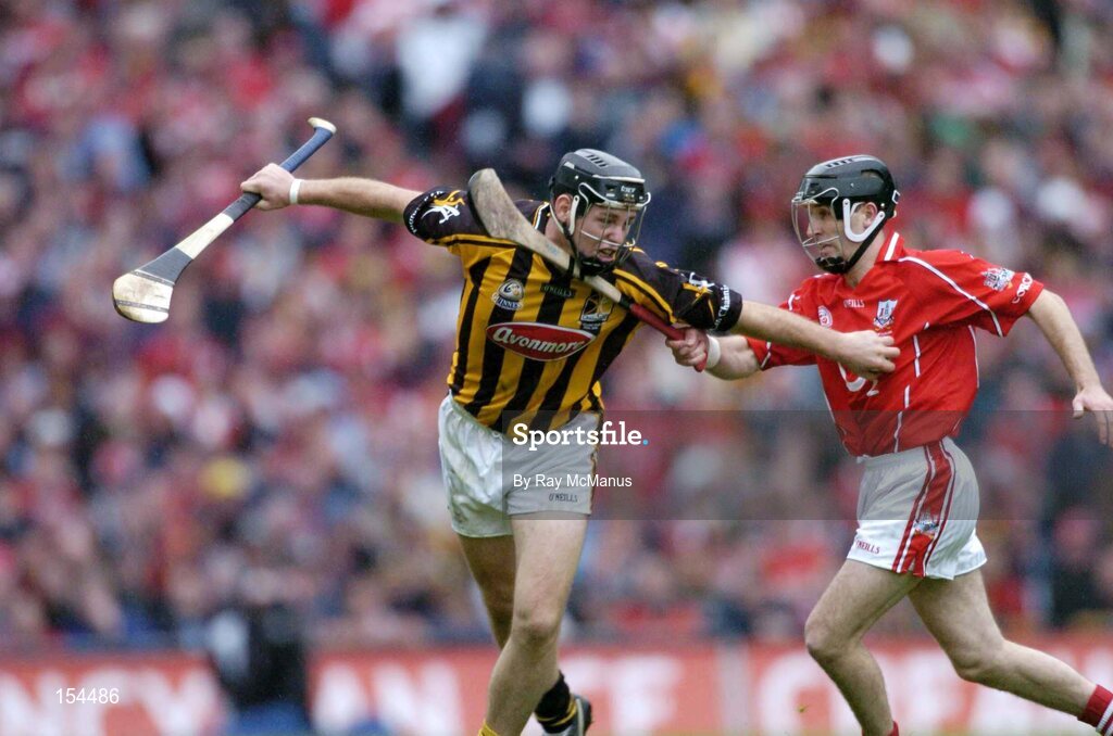 12 September 2004; Ken Coogan, Kilkenny, in action against Ben O'Connor, Cork. Guinness All-Ireland Senior Hurling Championship Final, Cork v Kilkenny, Croke Park, Dublin. Picture credit; Ray McManus / SPORTSFILE *** Local Caption *** Any photograph taken by SPORTSFILE during, or in connection with, the 2004 Guinness All-Ireland Hurling Final which displays GAA logos or contains an image or part of an image of any GAA intellectual property, or, which contains images of a GAA player/players in their playing uniforms, may only be used for editorial and non-advertising purposes.  Use of photographs for advertising, as posters or for purchase separately is strictly prohibited unless prior written approval has been obtained from the Gaelic Athletic Association.