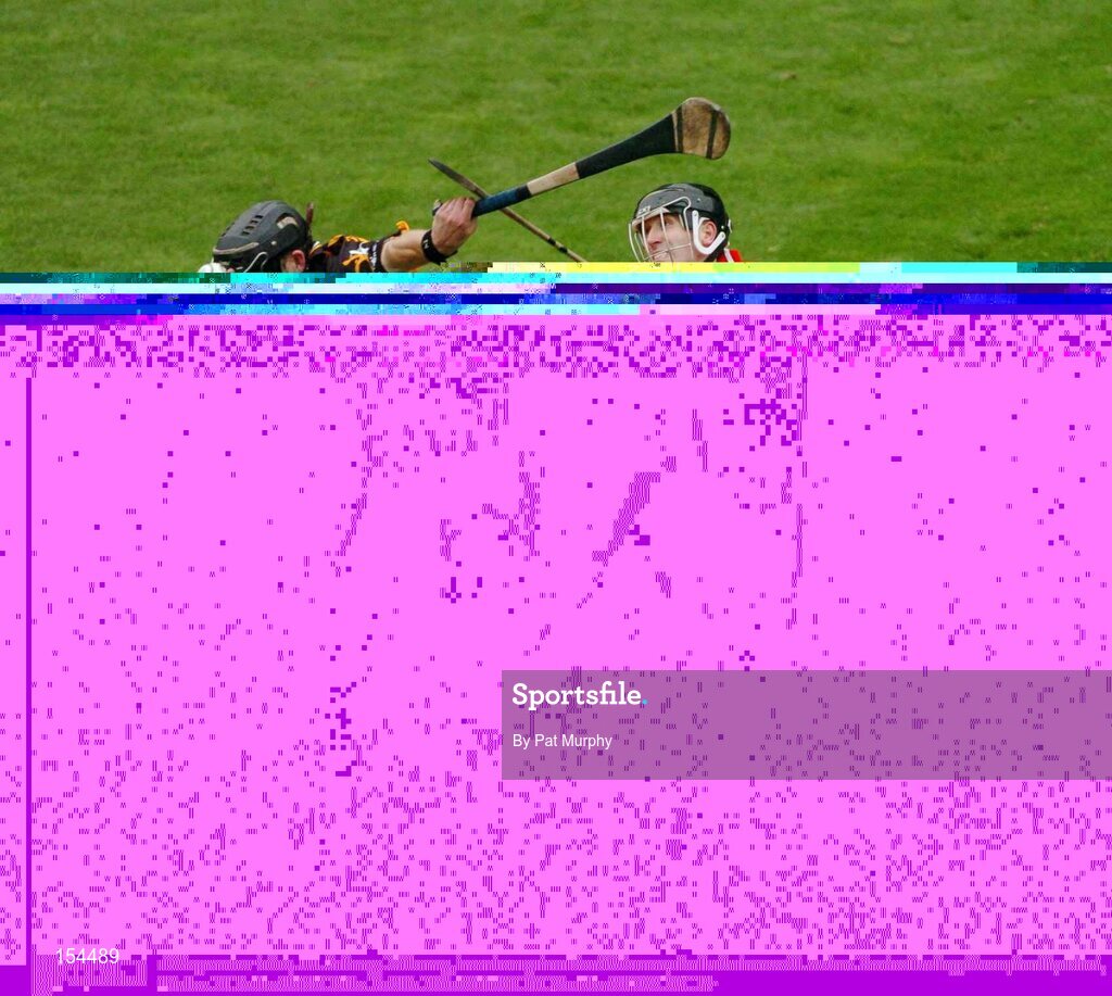 12 September 2004; J.J. Delaney, Kilkenny, in action against Ben O'Connor, Cork. Guinness All-Ireland Senior Hurling Championship Final, Cork v Kilkenny, Croke Park, Dublin. Picture credit; Pat Murphy / SPORTSFILE *** Local Caption *** Any photograph taken by SPORTSFILE during, or in connection with, the 2004 Guinness All-Ireland Hurling Final which displays GAA logos or contains an image or part of an image of any GAA intellectual property, or, which contains images of a GAA player/players in their playing uniforms, may only be used for editorial and non-advertising purposes.  Use of photographs for advertising, as posters or for purchase separately is strictly prohibited unless prior written approval has been obtained from the Gaelic Athletic Association.