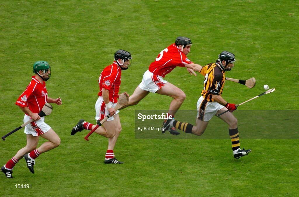 12 September 2004; DJ Carey, Kilkenny, in action against John Gardiner, Ben O'Connor, centre, and Jerry O'Connor, left, Cork. Guinness All-Ireland Senior Hurling Championship Final, Cork v Kilkenny, Croke Park, Dublin. Picture credit; Pat Murphy / SPORTSFILE *** Local Caption *** Any photograph taken by SPORTSFILE during, or in connection with, the 2004 Guinness All-Ireland Hurling Final which displays GAA logos or contains an image or part of an image of any GAA intellectual property, or, which contains images of a GAA player/players in their playing uniforms, may only be used for editorial and non-advertising purposes.  Use of photographs for advertising, as posters or for purchase separately is strictly prohibited unless prior written approval has been obtained from the Gaelic Athletic Association.