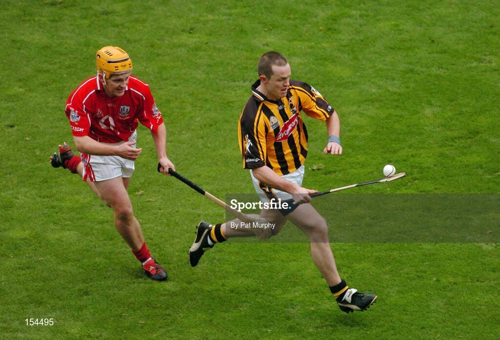 12 September 2004; Michael Kavanagh, Kilkenny, in action against Joe Deane, Cork. Guinness All-Ireland Senior Hurling Championship Final, Cork v Kilkenny, Croke Park, Dublin. Picture credit; Pat Murphy / SPORTSFILE *** Local Caption *** Any photograph taken by SPORTSFILE during, or in connection with, the 2004 Guinness All-Ireland Hurling Final which displays GAA logos or contains an image or part of an image of any GAA intellectual property, or, which contains images of a GAA player/players in their playing uniforms, may only be used for editorial and non-advertising purposes.  Use of photographs for advertising, as posters or for purchase separately is strictly prohibited unless prior written approval has been obtained from the Gaelic Athletic Association.