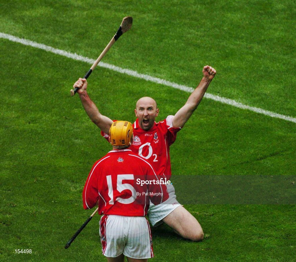 12 September 2004; Cork's Brian Corcoran celebrates the last point of the game with team-mate Joe Deane, 15. Guinness All-Ireland Senior Hurling Championship Final, Cork v Kilkenny, Croke Park, Dublin. Picture credit; Pat Murphy / SPORTSFILE *** Local Caption *** Any photograph taken by SPORTSFILE during, or in connection with, the 2004 Guinness All-Ireland Hurling Final which displays GAA logos or contains an image or part of an image of any GAA intellectual property, or, which contains images of a GAA player/players in their playing uniforms, may only be used for editorial and non-advertising purposes.  Use of photographs for advertising, as posters or for purchase separately is strictly prohibited unless prior written approval has been obtained from the Gaelic Athletic Association.
