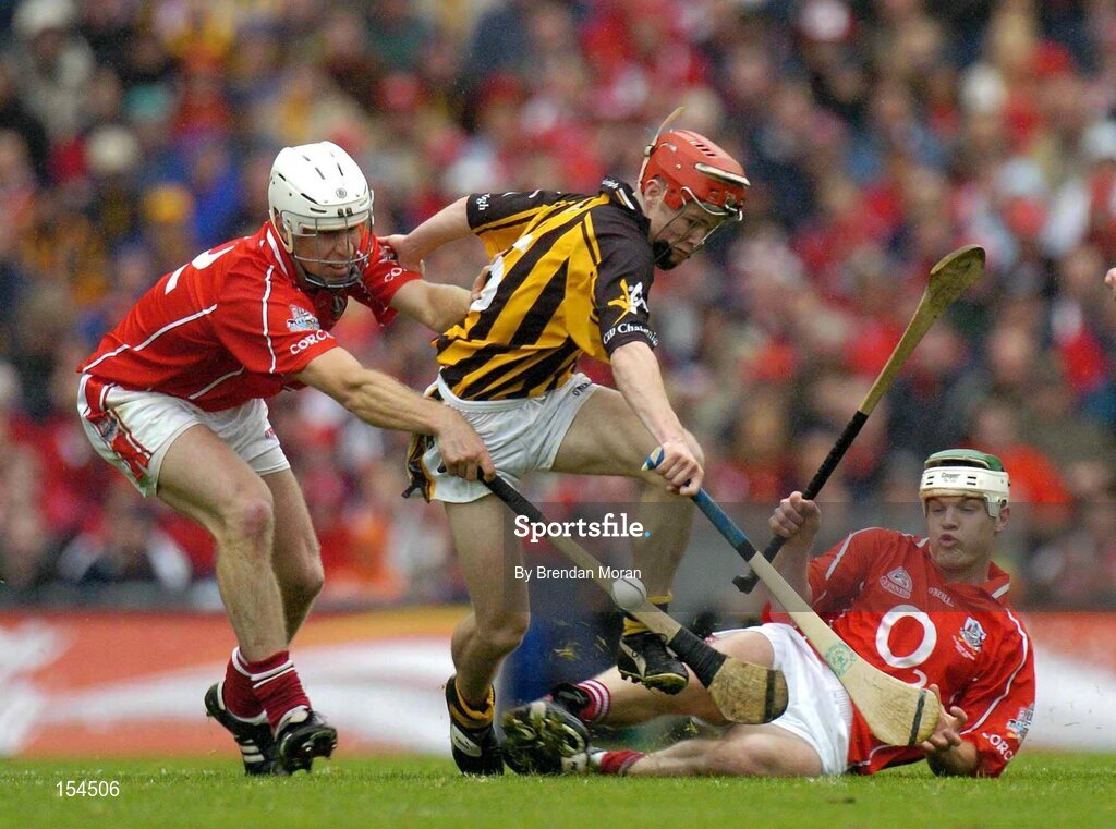 12 September 2004; Tommy Walsh, Kilkenny, in action against Timmy McCarthy, left, and Niall McCarthy, Cork. Guinness All-Ireland Senior Hurling Championship Final, Cork v Kilkenny, Croke Park, Dublin. Picture credit; Brendan Moran / SPORTSFILE *** Local Caption *** Any photograph taken by SPORTSFILE during, or in connection with, the 2004 Guinness All-Ireland Hurling Final which displays GAA logos or contains an image or part of an image of any GAA intellectual property, or, which contains images of a GAA player/players in their playing uniforms, may only be used for editorial and non-advertising purposes.  Use of photographs for advertising, as posters or for purchase separately is strictly prohibited unless prior written approval has been obtained from the Gaelic Athletic Association.