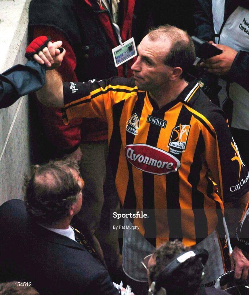 12 September 2004; DJ Carey, Kilkenny, is consoled after defeat to Cork. Guinness All-Ireland Senior Hurling Championship Final, Cork v Kilkenny, Croke Park, Dublin. Picture credit; Pat Murphy / SPORTSFILE *** Local Caption *** Any photograph taken by SPORTSFILE during, or in connection with, the 2004 Guinness All-Ireland Hurling Final which displays GAA logos or contains an image or part of an image of any GAA intellectual property, or, which contains images of a GAA player/players in their playing uniforms, may only be used for editorial and non-advertising purposes.  Use of photographs for advertising, as posters or for purchase separately is strictly prohibited unless prior written approval has been obtained from the Gaelic Athletic Association.
