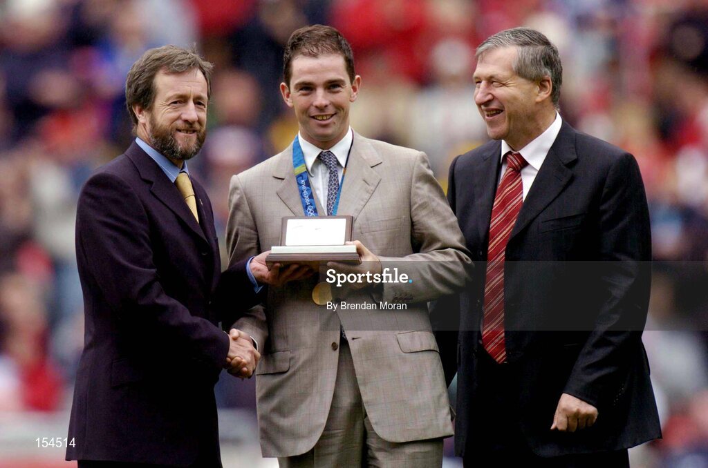 12 September 2004; President of the GAA Sean Kelly, makes a special presentation to Irish Olympic Gold Medallist Cian O'Connor, in the company of Liam Mulvihill, Ard Stiurthoir of the GAA, at half-time. Guinness All-Ireland Senior Hurling Championship Final, Cork v Kilkenny, Croke Park, Dublin. Picture credit; Brendan Moran / SPORTSFILE *** Local Caption *** Any photograph taken by SPORTSFILE during, or in connection with, the 2004 Guinness All-Ireland Hurling Final which displays GAA logos or contains an image or part of an image of any GAA intellectual property, or, which contains images of a GAA player/players in their playing uniforms, may only be used for editorial and non-advertising purposes.  Use of photographs for advertising, as posters or for purchase separately is strictly prohibited unless prior written approval has been obtained from the Gaelic Athletic Association.