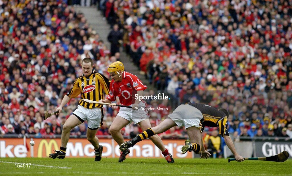 12 September 2004; Joe Deane, Cork, gets the sliotar past Kilkenny defender Michael Kavanagh, and goalkeeper James McGarry, only for it to go wide. Guinness All-Ireland Senior Hurling Championship Final, Cork v Kilkenny, Croke Park, Dublin. Picture credit; Brendan Moran / SPORTSFILE *** Local Caption *** Any photograph taken by SPORTSFILE during, or in connection with, the 2004 Guinness All-Ireland Hurling Final which displays GAA logos or contains an image or part of an image of any GAA intellectual property, or, which contains images of a GAA player/players in their playing uniforms, may only be used for editorial and non-advertising purposes.  Use of photographs for advertising, as posters or for purchase separately is strictly prohibited unless prior written approval has been obtained from the Gaelic Athletic Association.