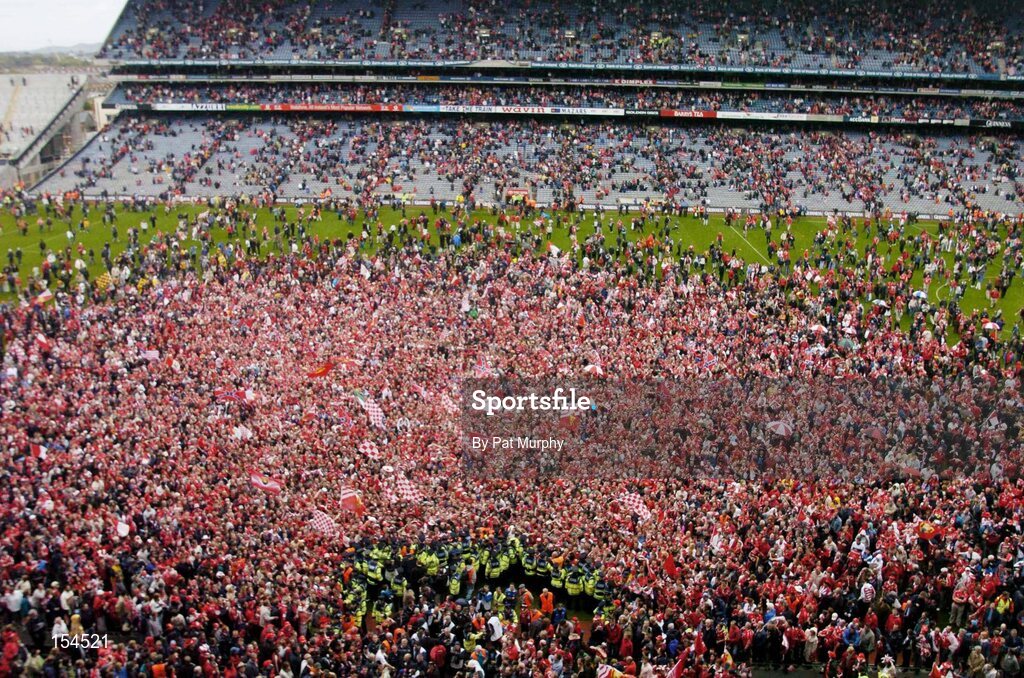 12 September 2004; Cork fans celebrate victory over Kilkenny. Guinness All-Ireland Senior Hurling Championship Final, Cork v Kilkenny, Croke Park, Dublin. Picture credit; Pat Murphy / SPORTSFILE *** Local Caption *** Any photograph taken by SPORTSFILE during, or in connection with, the 2004 Guinness All-Ireland Hurling Final which displays GAA logos or contains an image or part of an image of any GAA intellectual property, or, which contains images of a GAA player/players in their playing uniforms, may only be used for editorial and non-advertising purposes.  Use of photographs for advertising, as posters or for purchase separately is strictly prohibited unless prior written approval has been obtained from the Gaelic Athletic Association.
