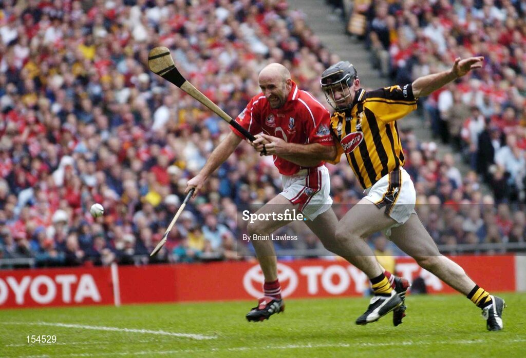 12 September 2004; Brian Corcoran, Cork, in action against Noel Hickey, Kilkenny. Guinness All-Ireland Senior Hurling Championship Final, Cork v Kilkenny, Croke Park, Dublin. Picture credit; Brian Lawless / SPORTSFILE *** Local Caption *** Any photograph taken by SPORTSFILE during, or in connection with, the 2004 Guinness All-Ireland Hurling Final which displays GAA logos or contains an image or part of an image of any GAA intellectual property, or, which contains images of a GAA player/players in their playing uniforms, may only be used for editorial and non-advertising purposes.  Use of photographs for advertising, as posters or for purchase separately is strictly prohibited unless prior written approval has been obtained from the Gaelic Athletic Association.