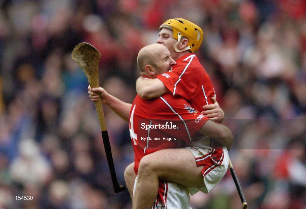12 September 2004; Cork's Brian Corcoran, left, and team-mate Joe Deane celebrate after victory over Kilkenny. Guinness All-Ireland Senior Hurling Championship Final, Cork v Kilkenny, Croke Park, Dublin. Picture credit; Damien Eagers / SPORTSFILE *** Local Caption *** Any photograph taken by SPORTSFILE during, or in connection with, the 2004 Guinness All-Ireland Hurling Final which displays GAA logos or contains an image or part of an image of any GAA intellectual property, or, which contains images of a GAA player/players in their playing uniforms, may only be used for editorial and non-advertising purposes.  Use of photographs for advertising, as posters or for purchase separately is strictly prohibited unless prior written approval has been obtained from the Gaelic Athletic Association.