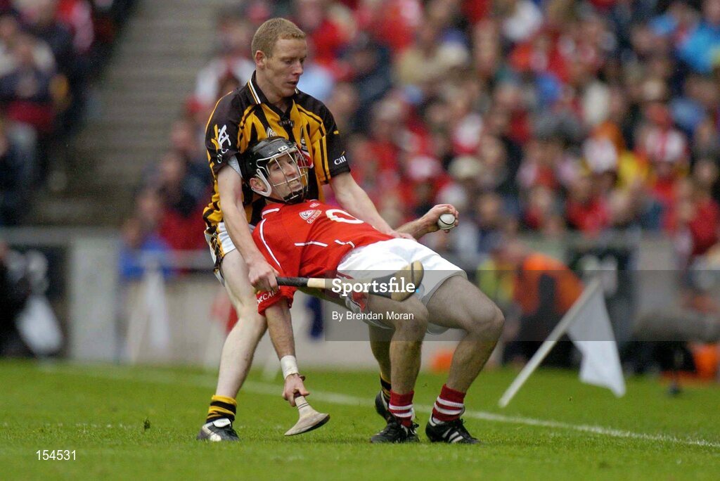 12 September 2004; Ben O'Connor, Cork, in action against James Ryall, Kilkenny. Guinness All-Ireland Senior Hurling Championship Final, Cork v Kilkenny, Croke Park, Dublin. Picture credit; Brendan Moran / SPORTSFILE *** Local Caption *** Any photograph taken by SPORTSFILE during, or in connection with, the 2004 Guinness All-Ireland Hurling Final which displays GAA logos or contains an image or part of an image of any GAA intellectual property, or, which contains images of a GAA player/players in their playing uniforms, may only be used for editorial and non-advertising purposes.  Use of photographs for advertising, as posters or for purchase separately is strictly prohibited unless prior written approval has been obtained from the Gaelic Athletic Association.