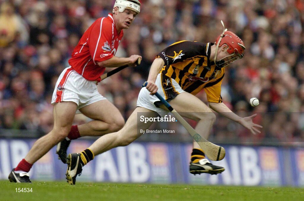 12 September 2004; Tommy Walsh, Kilkenny, in action against Niall McCarthy, Cork. Guinness All-Ireland Senior Hurling Championship Final, Cork v Kilkenny, Croke Park, Dublin. Picture credit; Brendan Moran / SPORTSFILE *** Local Caption *** Any photograph taken by SPORTSFILE during, or in connection with, the 2004 Guinness All-Ireland Hurling Final which displays GAA logos or contains an image or part of an image of any GAA intellectual property, or, which contains images of a GAA player/players in their playing uniforms, may only be used for editorial and non-advertising purposes.  Use of photographs for advertising, as posters or for purchase separately is strictly prohibited unless prior written approval has been obtained from the Gaelic Athletic Association.