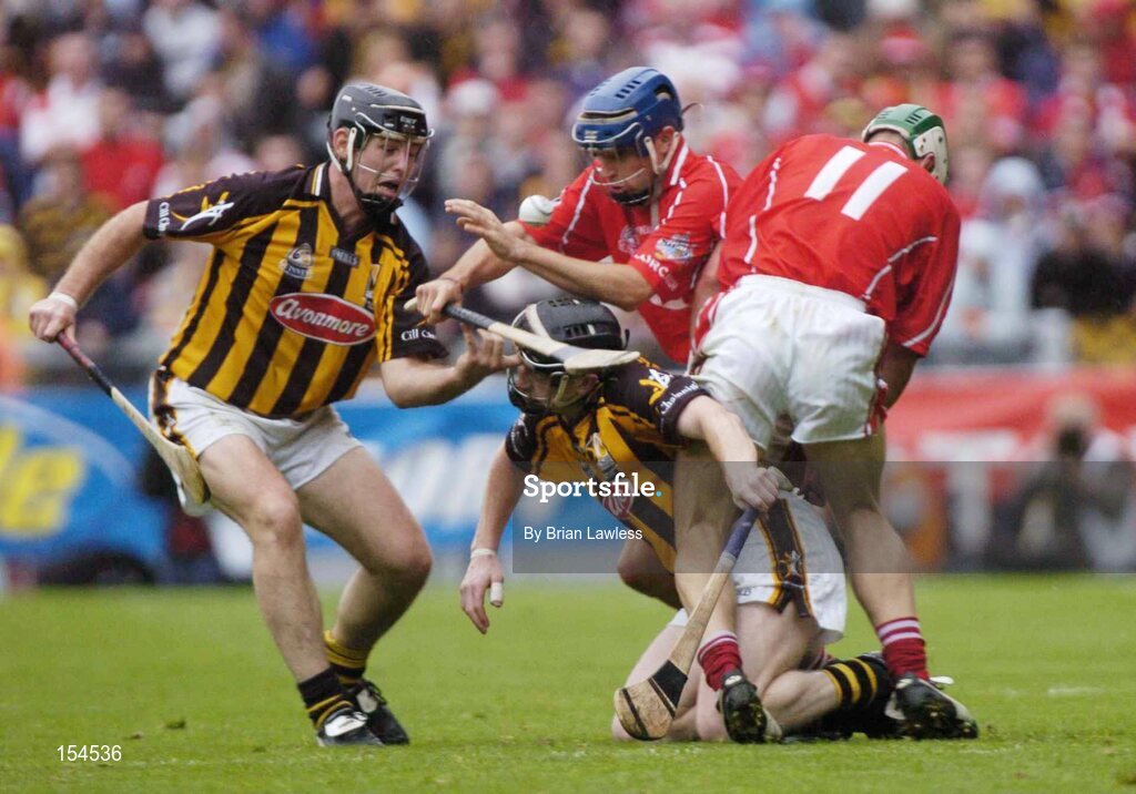 12 September 2004; Tom Kenny and Niall McCarthy (11), Cork, in action against Ken Coogan, left, and Peter Barry, Kilkenny. Guinness All-Ireland Senior Hurling Championship Final, Cork v Kilkenny, Croke Park, Dublin. Picture credit; Brian Lawless / SPORTSFILE *** Local Caption *** Any photograph taken by SPORTSFILE during, or in connection with, the 2004 Guinness All-Ireland Hurling Final which displays GAA logos or contains an image or part of an image of any GAA intellectual property, or, which contains images of a GAA player/players in their playing uniforms, may only be used for editorial and non-advertising purposes.  Use of photographs for advertising, as posters or for purchase separately is strictly prohibited unless prior written approval has been obtained from the Gaelic Athletic Association.