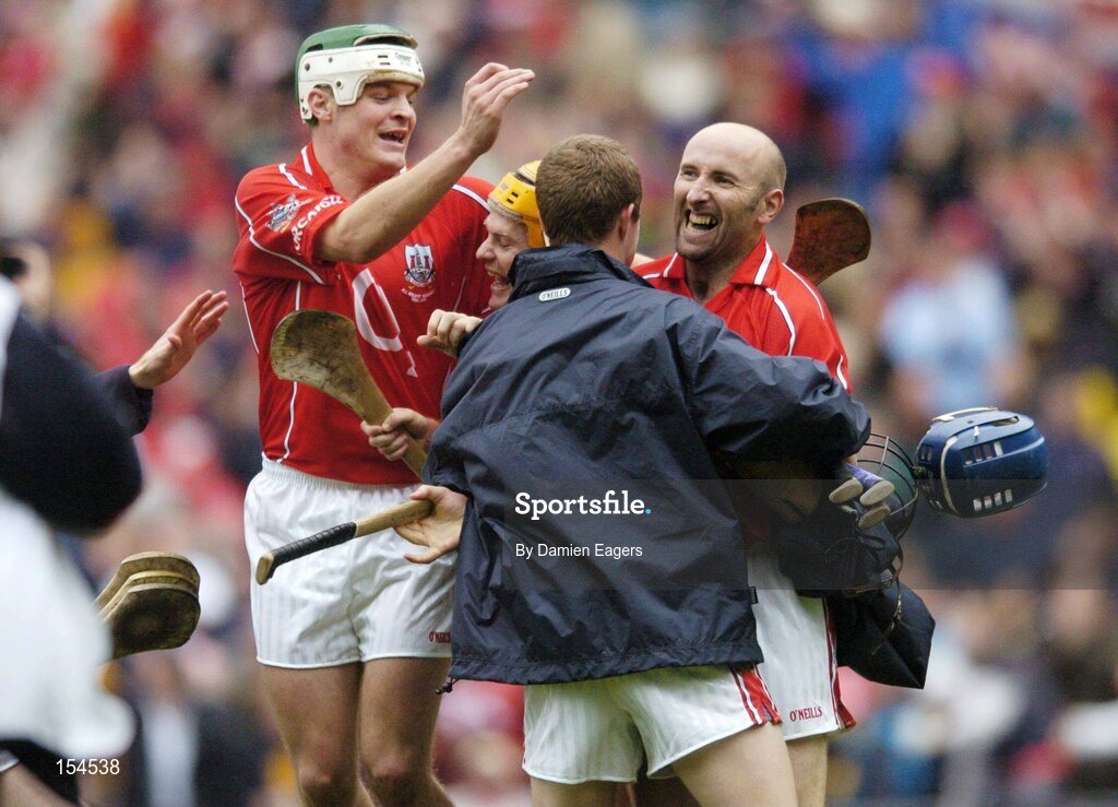 12 September 2004; Cork players, l to r, Niall McCarthy, Joe Deane and Brian Corcoran celebrate with a substitute after victory over Kilkenny. Guinness All-Ireland Senior Hurling Championship Final, Cork v Kilkenny, Croke Park, Dublin. Picture credit; Damien Eagers / SPORTSFILE *** Local Caption *** Any photograph taken by SPORTSFILE during, or in connection with, the 2004 Guinness All-Ireland Hurling Final which displays GAA logos or contains an image or part of an image of any GAA intellectual property, or, which contains images of a GAA player/players in their playing uniforms, may only be used for editorial and non-advertising purposes.  Use of photographs for advertising, as posters or for purchase separately is strictly prohibited unless prior written approval has been obtained from the Gaelic Athletic Association.