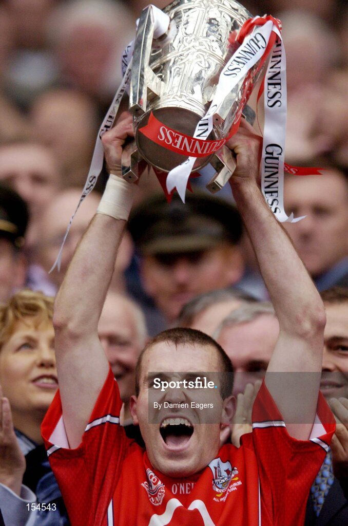 12 September 2004; Cork captain Ben O'Connor lifts the Liam MacCarthy cup. Guinness All-Ireland Senior Hurling Championship Final, Cork v Kilkenny, Croke Park, Dublin. Picture credit; Damien Eagers / SPORTSFILE *** Local Caption *** Any photograph taken by SPORTSFILE during, or in connection with, the 2004 Guinness All-Ireland Hurling Final which displays GAA logos or contains an image or part of an image of any GAA intellectual property, or, which contains images of a GAA player/players in their playing uniforms, may only be used for editorial and non-advertising purposes.  Use of photographs for advertising, as posters or for purchase separately is strictly prohibited unless prior written approval has been obtained from the Gaelic Athletic Association.