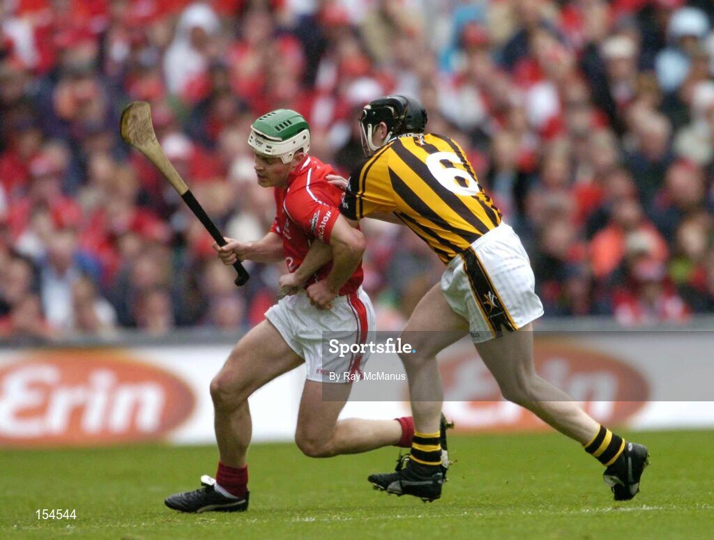 12 September 2004; Niall McCarthy, Cork, in action against Peter Barry, Kilkenny. Guinness All-Ireland Senior Hurling Championship Final, Cork v Kilkenny, Croke Park, Dublin. Picture credit; Ray McManus / SPORTSFILE *** Local Caption *** Any photograph taken by SPORTSFILE during, or in connection with, the 2004 Guinness All-Ireland Hurling Final which displays GAA logos or contains an image or part of an image of any GAA intellectual property, or, which contains images of a GAA player/players in their playing uniforms, may only be used for editorial and non-advertising purposes.  Use of photographs for advertising, as posters or for purchase separately is strictly prohibited unless prior written approval has been obtained from the Gaelic Athletic Association.