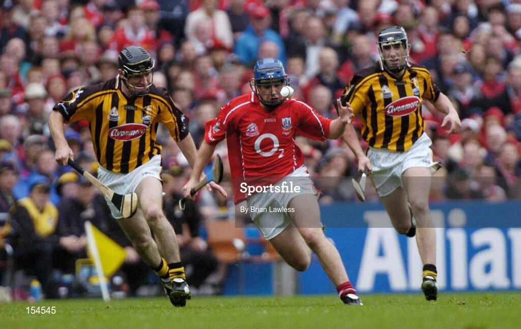 12 September 2004; Kieran Murphy, Cork, in action against Derek Lyng, left, and Ken Coogan, Kilkenny. Guinness All-Ireland Senior Hurling Championship Final, Cork v Kilkenny, Croke Park, Dublin. Picture credit; Brian Lawless / SPORTSFILE *** Local Caption *** Any photograph taken by SPORTSFILE during, or in connection with, the 2004 Guinness All-Ireland Hurling Final which displays GAA logos or contains an image or part of an image of any GAA intellectual property, or, which contains images of a GAA player/players in their playing uniforms, may only be used for editorial and non-advertising purposes.  Use of photographs for advertising, as posters or for purchase separately is strictly prohibited unless prior written approval has been obtained from the Gaelic Athletic Association.