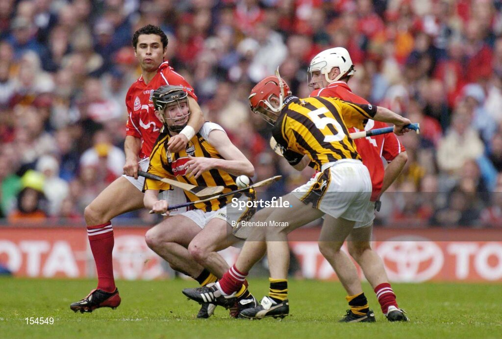 12 September 2004; Sean Og O'hAilpin, left, and Timmy McCarthy, Cork, contest possession with Martin Comerford and Tommy Walsh (5), Kilkenny. Guinness All-Ireland Senior Hurling Championship Final, Cork v Kilkenny, Croke Park, Dublin. Picture credit; Brendan Moran / SPORTSFILE *** Local Caption *** Any photograph taken by SPORTSFILE during, or in connection with, the 2004 Guinness All-Ireland Hurling Final which displays GAA logos or contains an image or part of an image of any GAA intellectual property, or, which contains images of a GAA player/players in their playing uniforms, may only be used for editorial and non-advertising purposes.  Use of photographs for advertising, as posters or for purchase separately is strictly prohibited unless prior written approval has been obtained from the Gaelic Athletic Association.