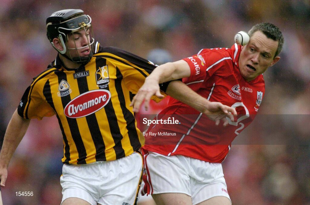 12 September 2004; John Browne, Cork, in action against Conor Phelan, Kilkenny. Guinness All-Ireland Senior Hurling Championship Final, Cork v Kilkenny, Croke Park, Dublin. Picture credit; Ray McManus / SPORTSFILE *** Local Caption *** Any photograph taken by SPORTSFILE during, or in connection with, the 2004 Guinness All-Ireland Hurling Final which displays GAA logos or contains an image or part of an image of any GAA intellectual property, or, which contains images of a GAA player/players in their playing uniforms, may only be used for editorial and non-advertising purposes.  Use of photographs for advertising, as posters or for purchase separately is strictly prohibited unless prior written approval has been obtained from the Gaelic Athletic Association.