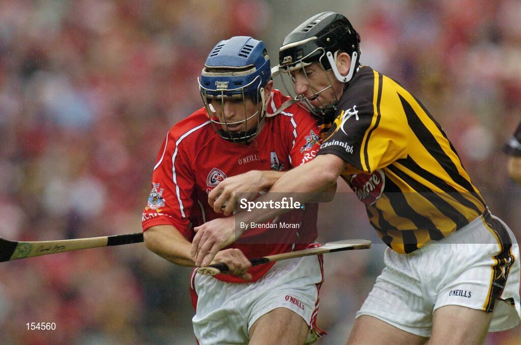 12 September 2004; Tom Kenny, Cork, in action against Derek Lyng, Kilkenny. Guinness All-Ireland Senior Hurling Championship Final, Cork v Kilkenny, Croke Park, Dublin. Picture credit; Brendan Moran / SPORTSFILE *** Local Caption *** Any photograph taken by SPORTSFILE during, or in connection with, the 2004 Guinness All-Ireland Hurling Final which displays GAA logos or contains an image or part of an image of any GAA intellectual property, or, which contains images of a GAA player/players in their playing uniforms, may only be used for editorial and non-advertising purposes.  Use of photographs for advertising, as posters or for purchase separately is strictly prohibited unless prior written approval has been obtained from the Gaelic Athletic Association.